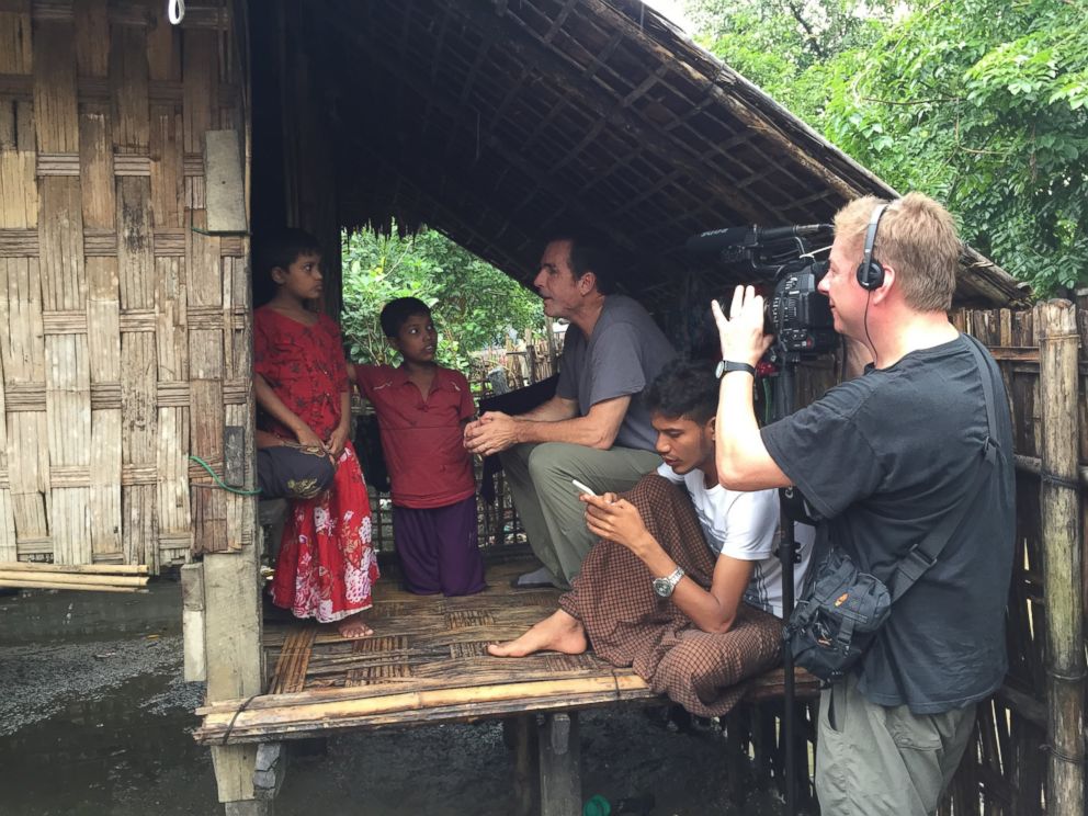 PHOTO: ABC News Bob Woodruff and cameraman Sean Keane interview a woman and her children inside the refugee camps outside of Sittwe, Myanmar.