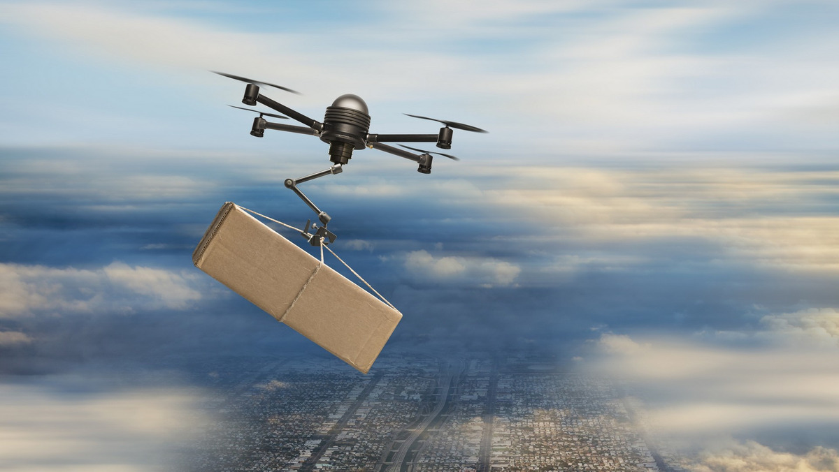 Aerial view of drone carrying package in cloudy sky