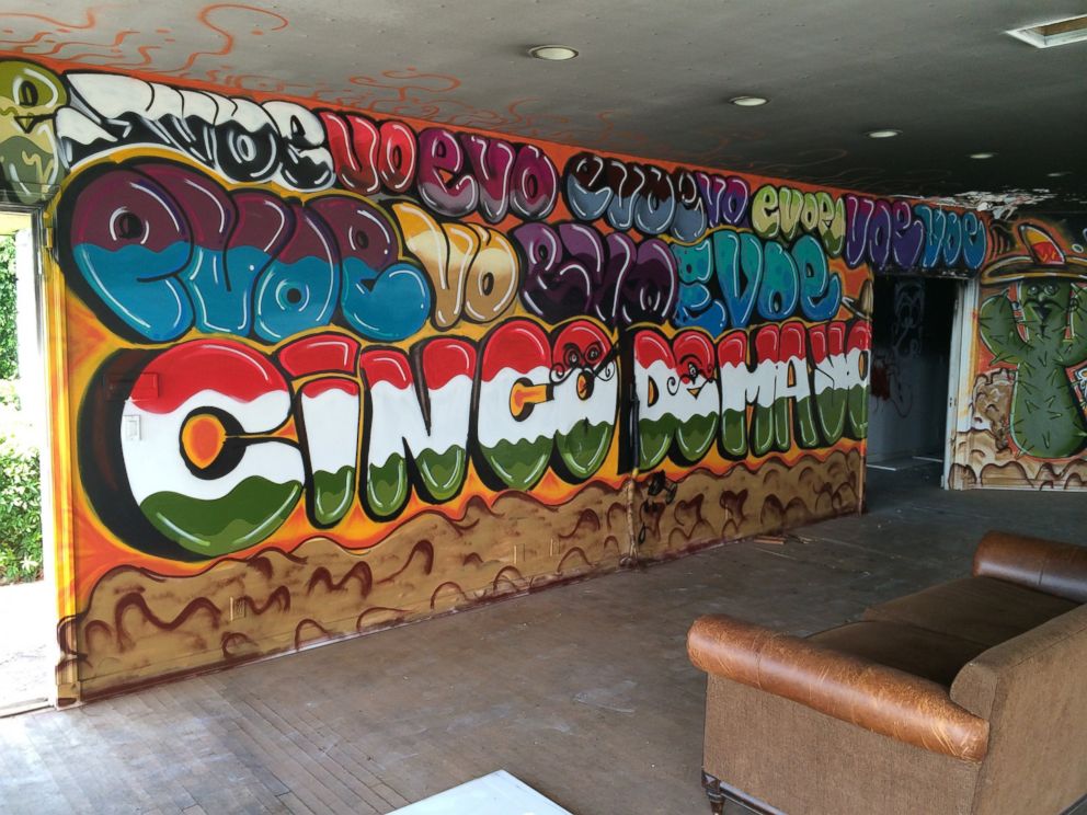 PHOTO: A graffiti-type wall painting is featured in the living room of Pablo Escobars former Miami Beach home.